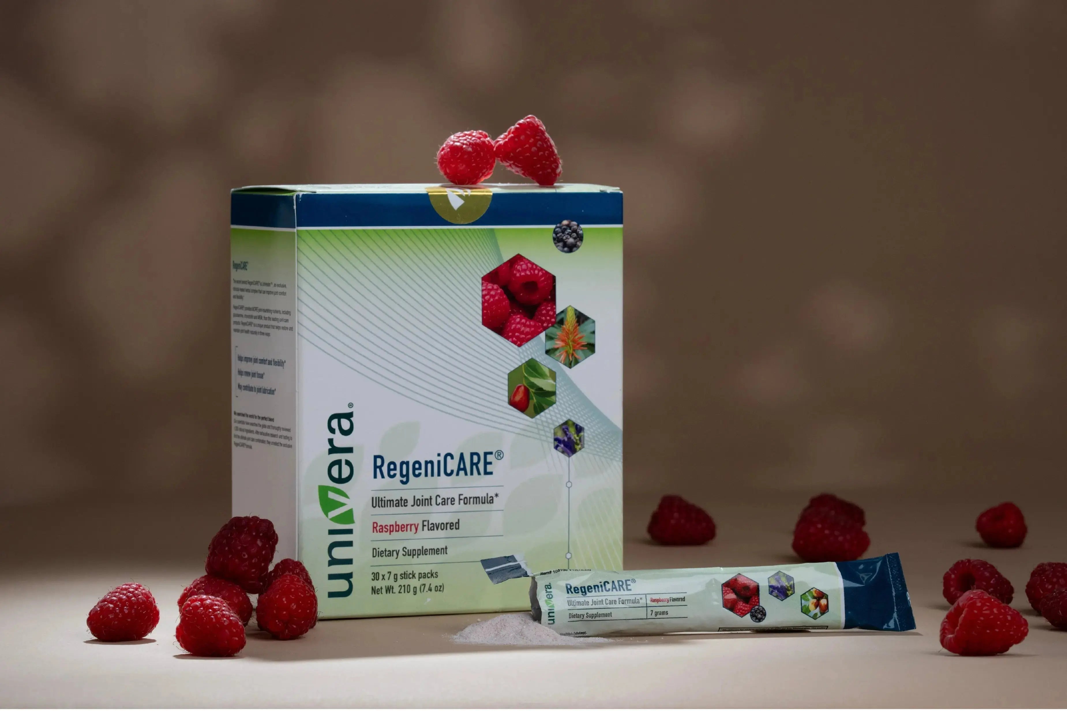 RegeniCARE® joint health supplement with fresh raspberries on a clean background.