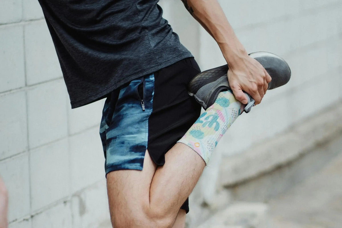 man stretching his legs outside