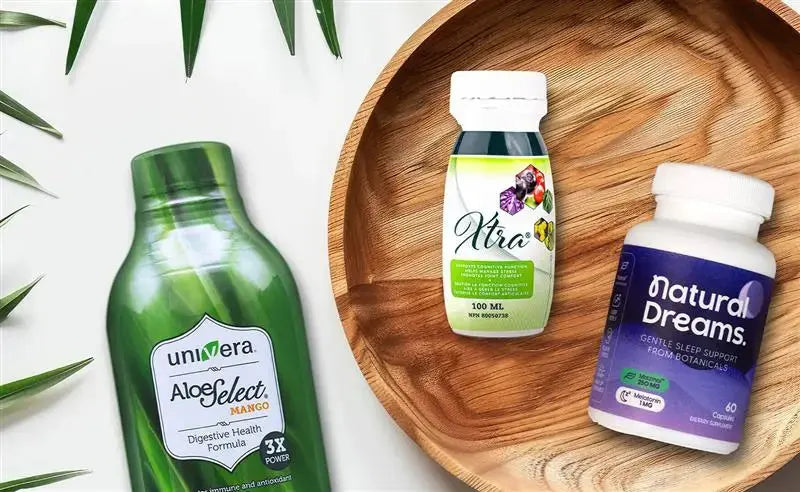 three bottles of univera products on a wood plate