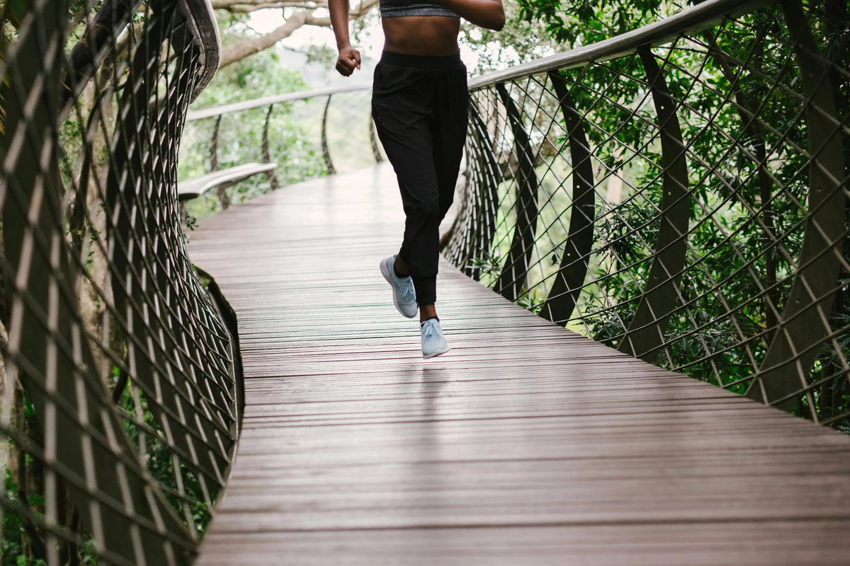 person running on a track in the woods