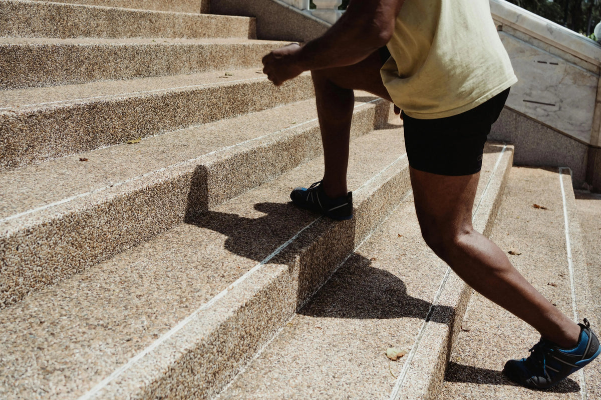 person climbing up a flight of stairs